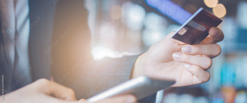 Business woman hand use credit cards and smartphones.Web banner.