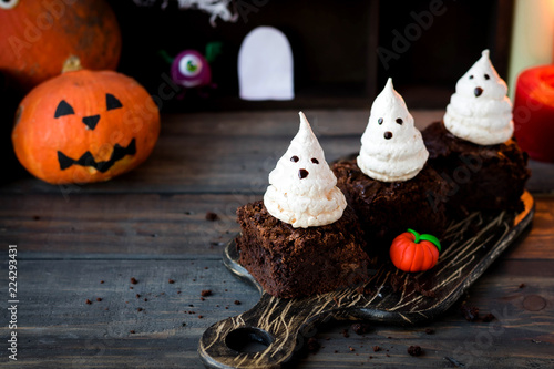 Brownie with ghosts of meringue as the idea of a dessert for Halloween