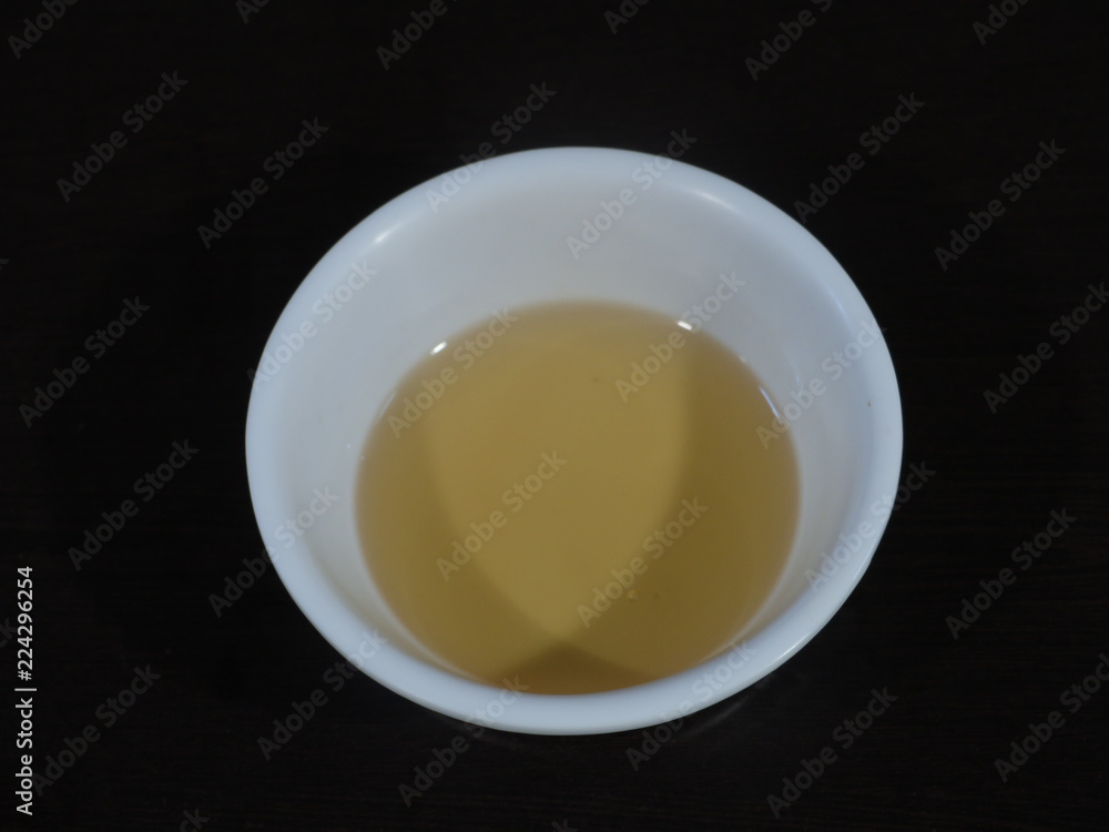 Sesame oil inn White Bowl on Wooden Background,Til ka Tel called in India, Tilli Ka Tel,Sesame oil,Bottle of sesame oil and sesame seeds isolated on white background Sesame oil inn White Bowl on Wooden Background,Til ka Tel called in India, Tilli Ka Tel,Sesame oil,Bottle of sesame oil and sesame seeds isolated on white background