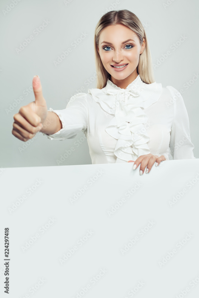 Business woman showing thumb up, smiling and holding white empty board background with copy space for advertising marketing or product placement. Successful businesswoman portrait Business woman showing thumb up, smiling and holding white empty board background with copy space for advertising marketing or product placement. Successful businesswoman portrait