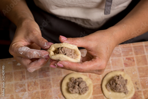 A woman is making pies