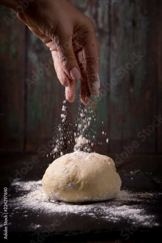 hand pours flour