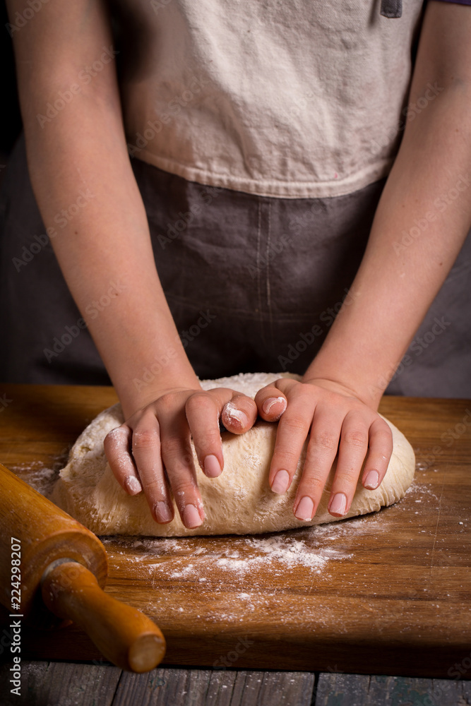 hands knead the dough