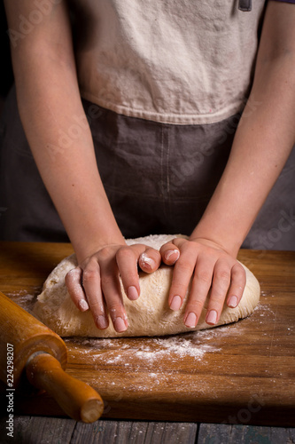 hands knead the dough