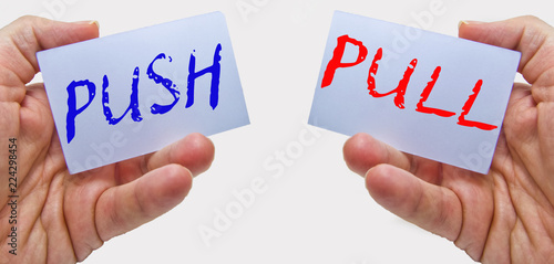 business man hands handling cards with push pull words. Marketing concept