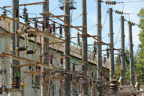 Part of old rusty high-voltage power plant with switches and disconnecters.