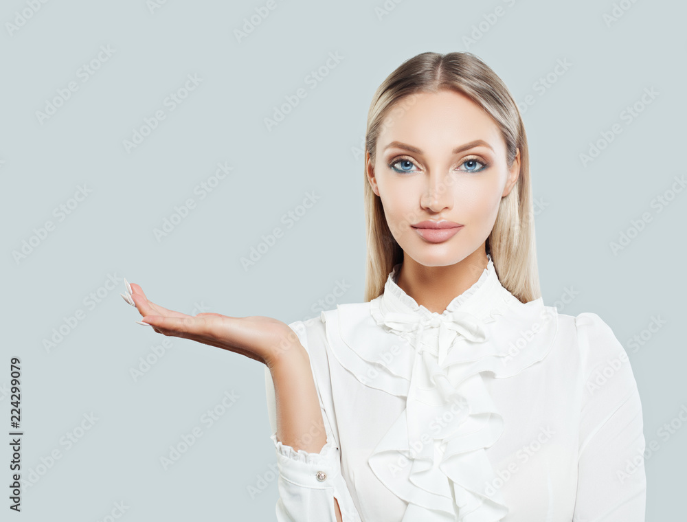 Blonde business woman showing empty open hand on white background. Businesswoman smiling, business and education concept Blonde business woman showing empty open hand on white background. Businesswoman smiling, business and education concept