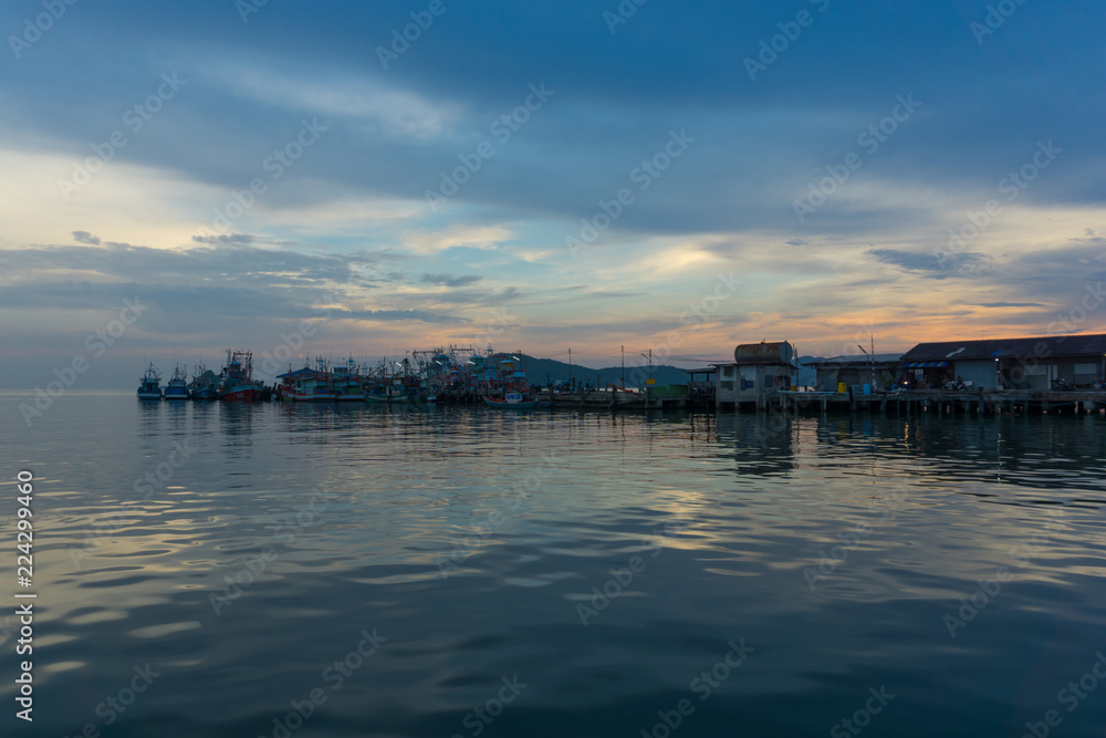 Thai traditional fishing boats are parking at jetty (Sattihip Bay) in a evening day