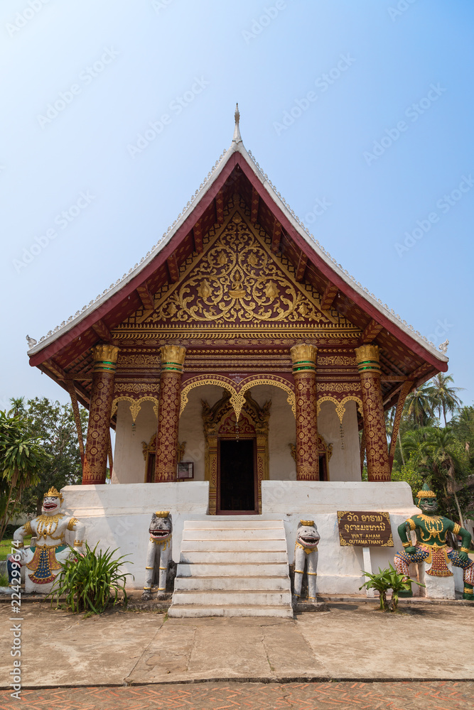 Small Buddhist Wat Aham Temple in Luang Prabang, Laos, viewed from the front on a sunny day.