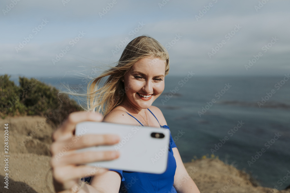 Cheerful woman smiling taking a selfie
