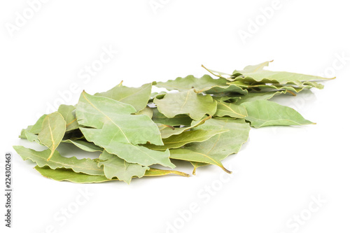Lot of whole dry olive green bay laurel leaves stack isolated on white background
