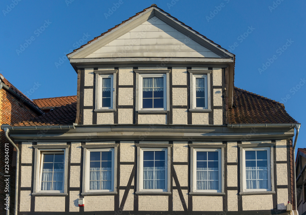 old timber framed house with blue sky background