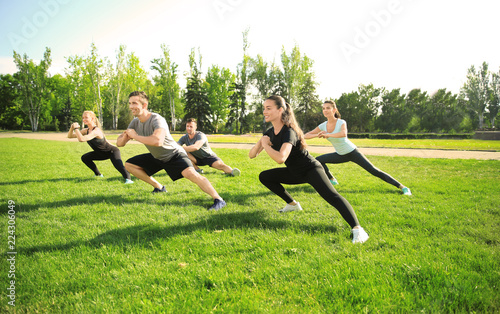 Group of sporty people training in park