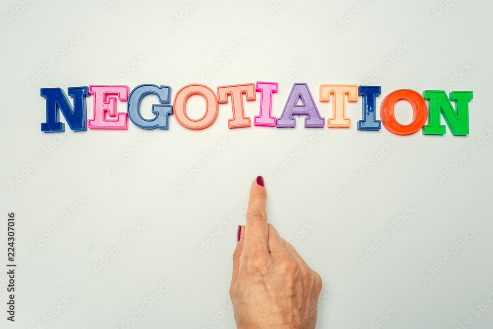 Fototapeta premium Word negotiation written in colorful plastic letters on white background