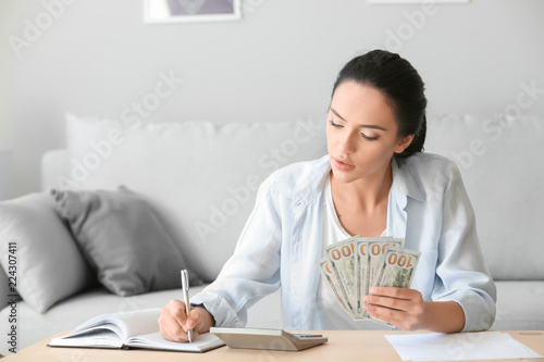Young woman counting money ...