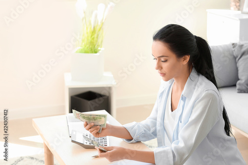 Young woman counting money ...