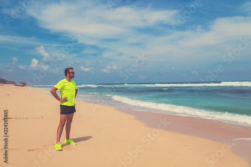 Exercising on a tropical sandy beach near sea / ocean.