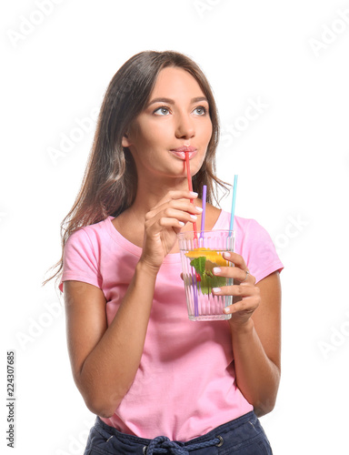 Young woman with glass of fresh lemonade on white background