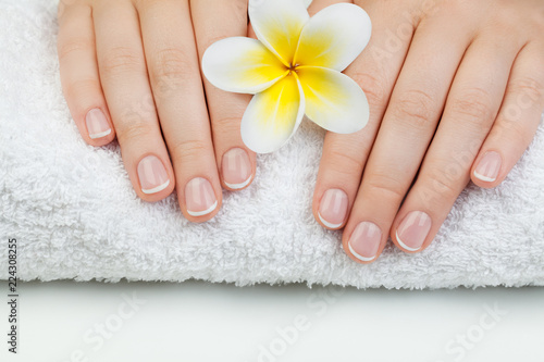 Beautiful female hands on white towel. Manicure concept