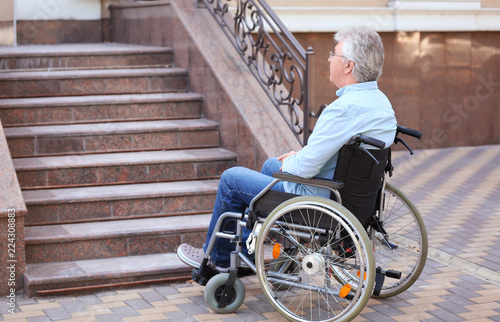 Senior man in wheelchair ne...