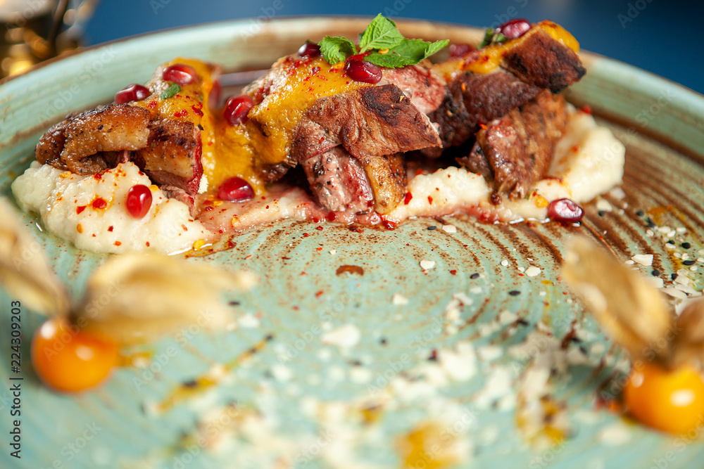 Delicious duck breast with mash potato and fruits on porcelain, Fine gastronomy Delicious duck breast with mash potato and fruits on porcelain, Fine gastronomy