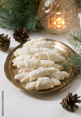 Traditional Romanian or Moldovan shortcake cookies with jam stuffing and a cup of tea on the background of winter decor. photo