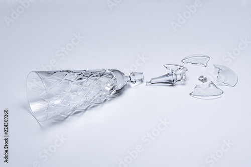 Broken crystal wine glass on white background © Makeev Petr