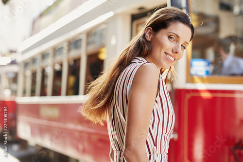  Young woman is walking down the city street