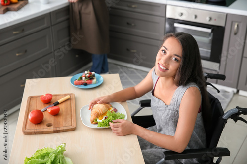 Young woman in wheelchair e...