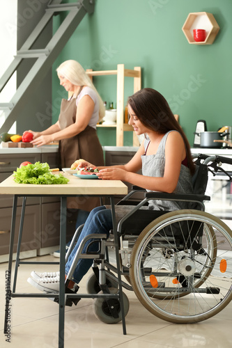 Young woman in wheelchair e...