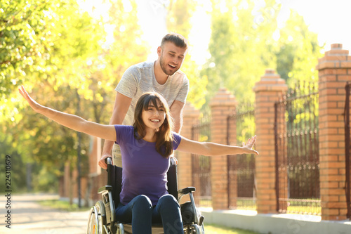 Happy young woman in wheelc...
