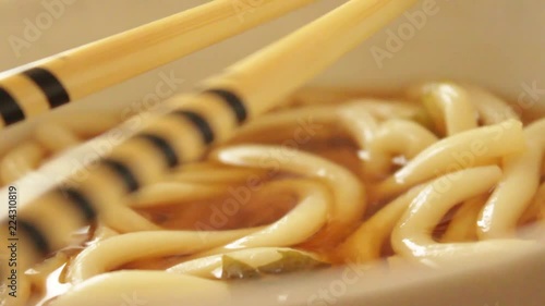 Japanese Udon Noodles with Miso Soup in bowl with chopsticks photo