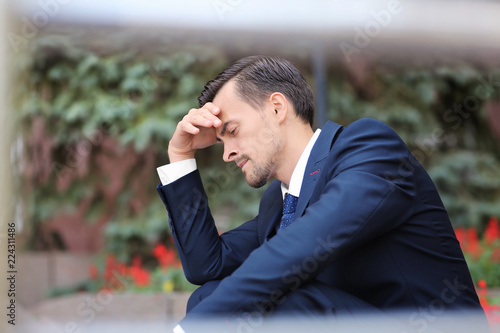 Handsome stressed businessm...