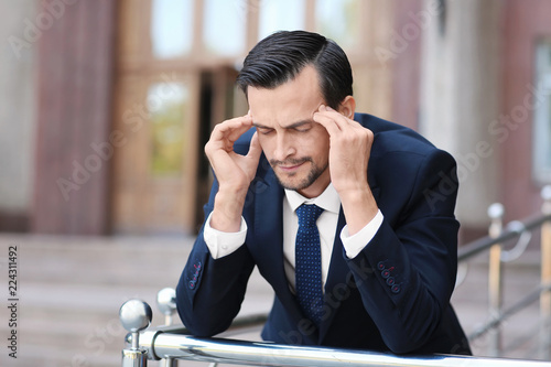 Handsome stressed businessm...