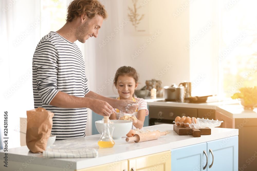 Father and daughter cooking together in kitchen