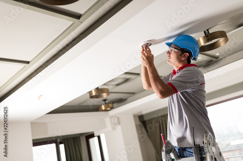 Man Installing Smoke Detector
