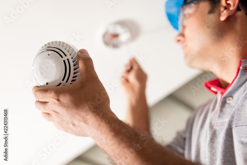 Man Installing Smoke Detector