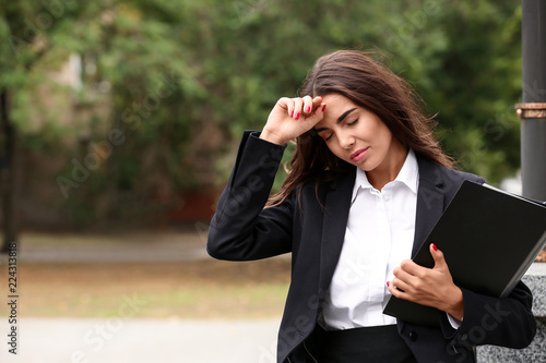 Stressed businesswoman with...