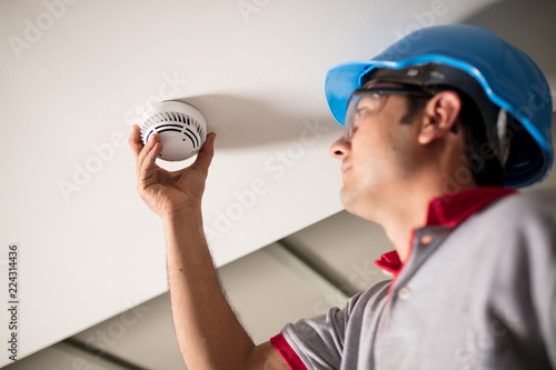 Man Installing Smoke Detector