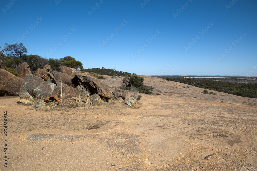 Hyden Australia, Boulders on top of wave rock, with salt lakes in background