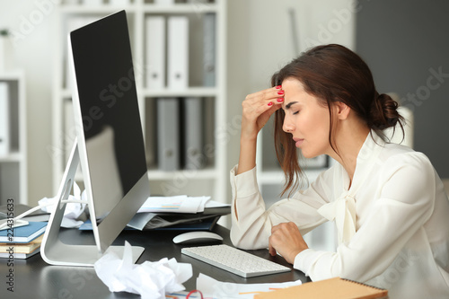 Tired businesswoman working...