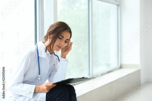 Tired female doctor sitting...