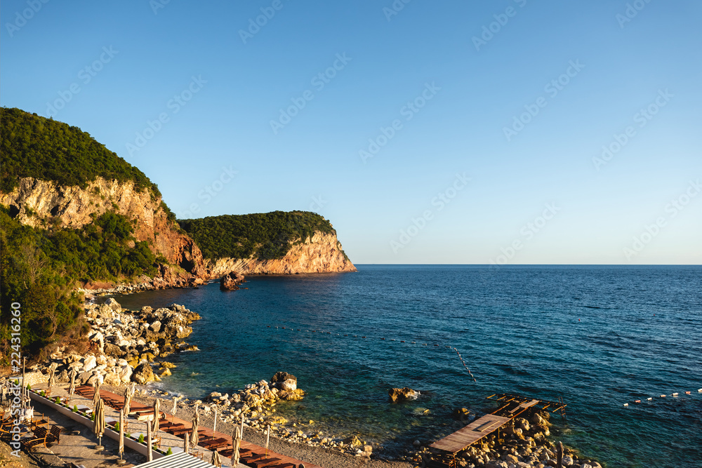 Beach with stones and mountains in Budva, Montenegro