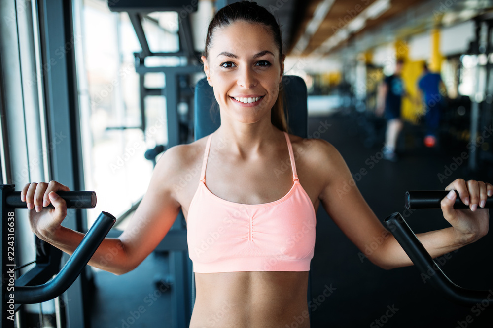 Woman working out in gym on machine Woman working out in gym on machine