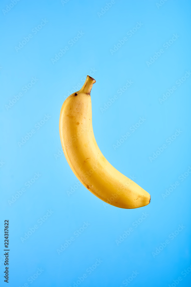 Yellow banana on a blue background Yellow banana on a blue background