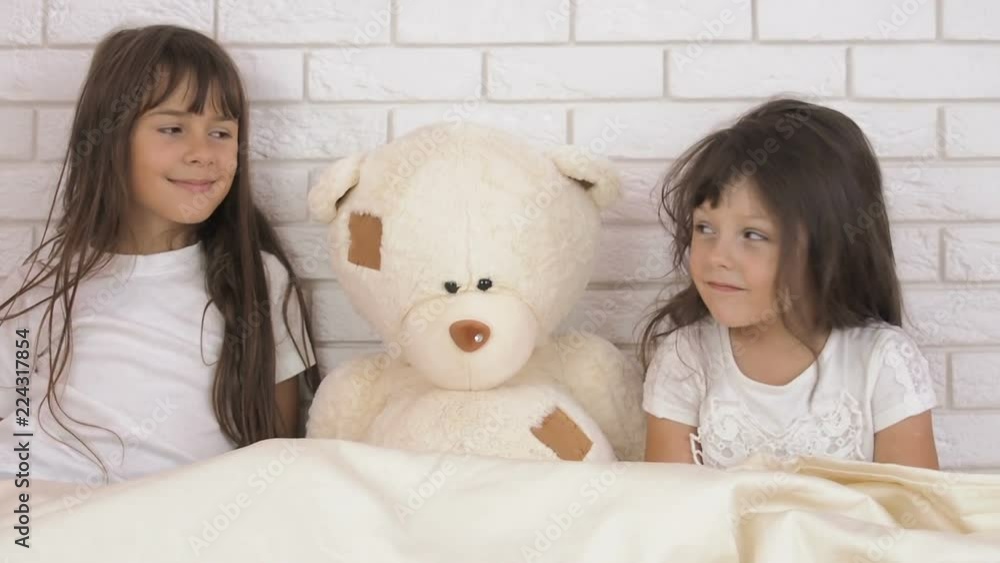 Happy children play with a teddy bear. Happy children play with a teddy bear.