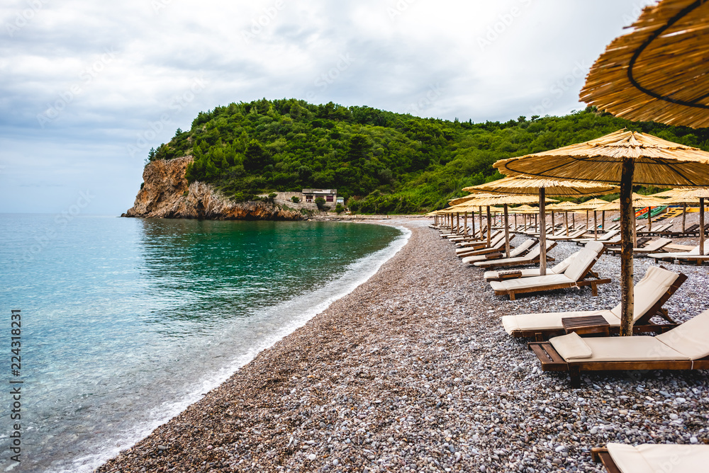 sun loungers on empty beach of adriatic sea in Budva, Montenegro