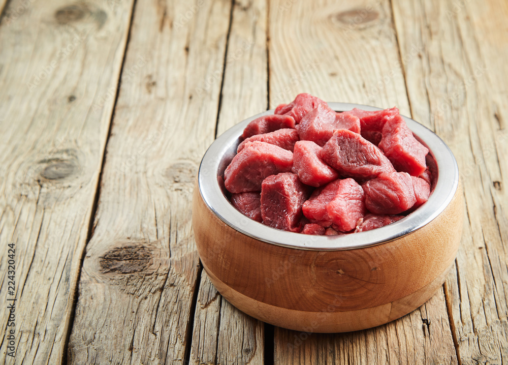 Fresh raw diced meat in a dog bowl Fresh raw diced meat in a dog bowl