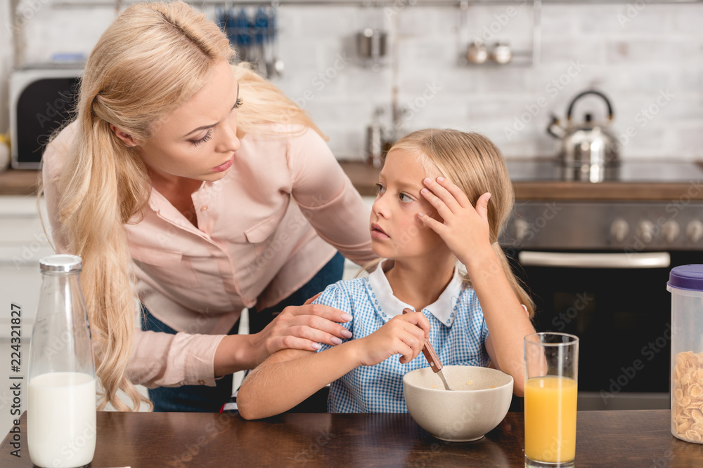 daughter complains about bad feeling to her mother during breakfast daughter complains about bad feeling to her mother during breakfast