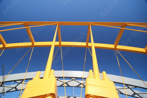 Bright yellow bridge named Hogeweidebrug over the Amsterdam-Rhine canal in Utrecht for traffic and Vleutenspoorbrug which is a trainbridge. photo